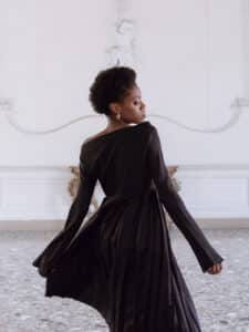 Girl with short afro hairstyle wearing a long black dress